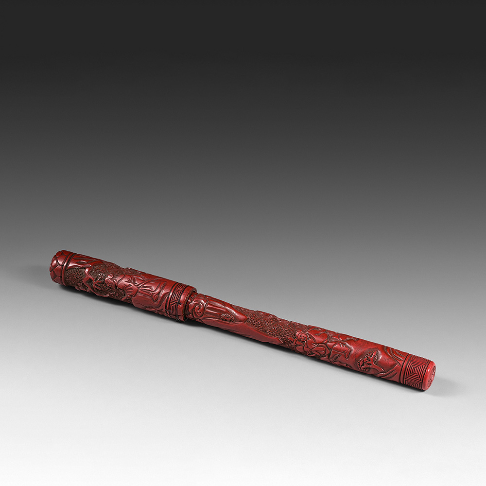 A carved red lacquer brush and cover depicting characters in a rocky landscape - 1